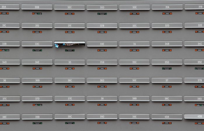 A grid of grey mailboxes with number labels showing an organized system.