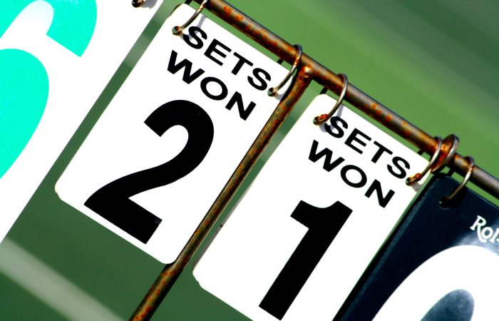 Close-up of a tennis scoreboard showing games won by each player.
