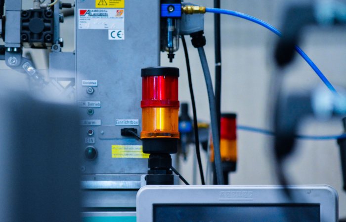 Detailed view of automated machinery with warning signals in an industrial setting.